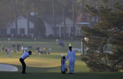 Defending champion Bubba Watson of the U.S. (L) hits his approach shot to the first green during a practice round in preparation for the 201 Defending champion Bubba Watson of the U.S. (L) hits his approach shot to the first green during a practice round in preparation for the 201