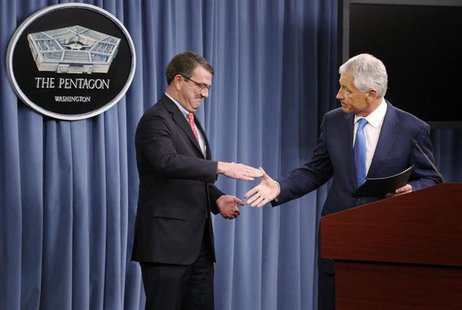 U.S. Secretary of Defense Chuck Hagel (R) shakes hands with Deputy Secretary of Defense Ash Carter as he departs a news conference about the U.S. Secretary of Defense Chuck Hagel (R) shakes hands with Deputy Secretary of Defense Ash Carter as he departs a news conference about the