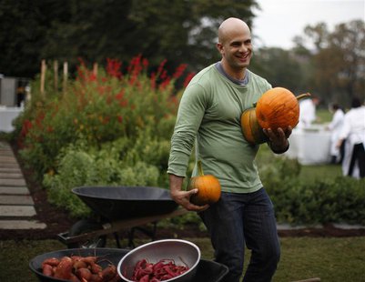 White House Chef Sam Kass drops freshly harvested pumpkins into a wheelbarrow during the fall harvest of the White House Kitchen Garden at t White House Chef Sam Kass drops freshly harvested pumpkins into a wheelbarrow during the fall harvest of the White House Kitchen Garden at t