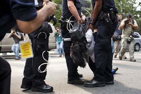 An Occupy Wall Street activist is arrested while protesting in the streets of New York's Financial District on the one-year anniversary of t An Occupy Wall Street activist is arrested while protesting in the streets of New York's Financial District on the one-year anniversary of t