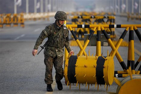 A South Korean soldier sets up a barricade at a checkpoint on the Grand Unification Bridge, which leads to the demilitarized zone separating A South Korean soldier sets up a barricade at a checkpoint on the Grand Unification Bridge, which leads to the demilitarized zone separating