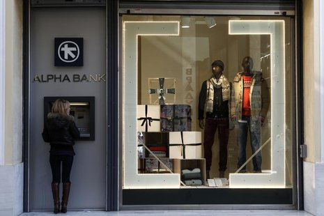 A woman makes a transaction at an ATM of an Alpha bank branch in Athens December 10, 2012. REUTERS/Yorgos Karahalis A woman makes a transaction at an ATM of an Alpha bank branch in Athens December 10, 2012. REUTERS/Yorgos Karahalis
