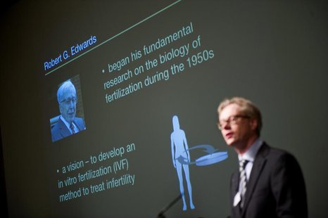 A picture of Robert Edwards of Britain is projected behind Christer Hoog of the Karolinska Institute as the winner of the 2010 Nobel Prize i A picture of Robert Edwards of Britain is projected behind Christer Hoog of the Karolinska Institute as the winner of the 2010 Nobel Prize i