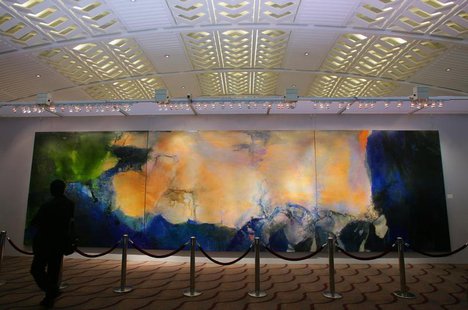 A visitor looks at a 2.8-metre by 10-metre triptych by Chinese painter Zao at Christie's auction house in Hong Kong. REUTERS/Bobby Yip A visitor looks at a 2.8-metre by 10-metre triptych by Chinese painter Zao at Christie's auction house in Hong Kong. REUTERS/Bobby Yip