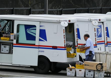 A U.S. postal worker loads up his truck with mail for delivery from the postal station in Carlsbad, California February 6, 2013. REUTERS/Mik A U.S. postal worker loads up his truck with mail for delivery from the postal station in Carlsbad, California February 6, 2013. REUTERS/Mik