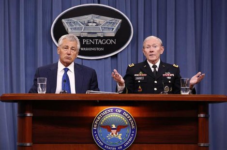 U.S. Defense Secretary Chuck Hagel (L) listens as Chairman of the Joint Chief of Staff General Martin Dempsey (R) speaks during a briefing o U.S. Defense Secretary Chuck Hagel (L) listens as Chairman of the Joint Chief of Staff General Martin Dempsey (R) speaks during a briefing o