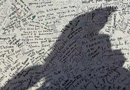 A mother and daughter cast shadows on one of many signboards placed at a memorial to those killed in the July 20 theater shootings in Aurora A mother and daughter cast shadows on one of many signboards placed at a memorial to those killed in the July 20 theater shootings in Aurora
