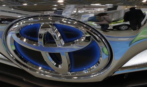 A visitor walking past cars is reflected on a Toyota car at the company's showroom in Tokyo February 5, 2013. REUTERS/Toru Hanai A visitor walking past cars is reflected on a Toyota car at the company's showroom in Tokyo February 5, 2013. REUTERS/Toru Hanai