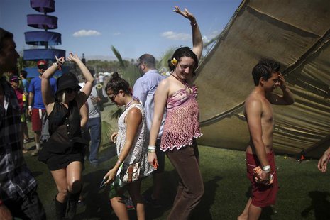 People dance on the final day of the Coachella Valley Music and Arts Festival in Indio, California April 15, 2012. REUTERS/David McNew People dance on the final day of the Coachella Valley Music and Arts Festival in Indio, California April 15, 2012. REUTERS/David McNew