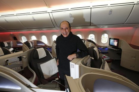 Qatar Airways CEO Akbar Al Baker poses for a photograph in the business class cabin of the new Boeing 787 Dreamliner after it arrived on it' Qatar Airways CEO Akbar Al Baker poses for a photograph in the business class cabin of the new Boeing 787 Dreamliner after it arrived on it'