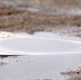 Home plate covered in rain
