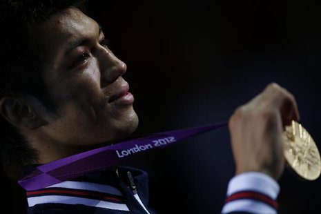Japan's Ryota Murata shows his gold medal during the presentation ceremony after the Men's Middle (75kg) gold medal boxing match at the Lond Japan's Ryota Murata shows his gold medal during the presentation ceremony after the Men's Middle (75kg) gold medal boxing match at the Lond