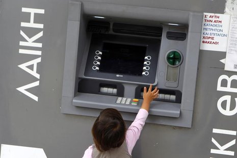 A child tries to reach an ATM machine at a branch of Laiki Bank in Nicosia March 30, 2013. REUTERS/Bogdan Cristel A child tries to reach an ATM machine at a branch of Laiki Bank in Nicosia March 30, 2013. REUTERS/Bogdan Cristel