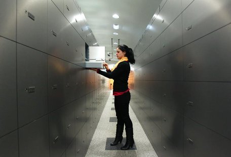 A woman takes a deposit box out of a compartment in the safe room of an Austrian bank in Vienna April 10, 2013. REUTERS/Heinz-Peter Bader A woman takes a deposit box out of a compartment in the safe room of an Austrian bank in Vienna April 10, 2013. REUTERS/Heinz-Peter Bader