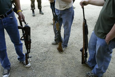 A group of men with automatic weapons for sale stand at the gun show at the Knob Creek Machine Gun Shoot near West Point, Kentucky April 9, A group of men with automatic weapons for sale stand at the gun show at the Knob Creek Machine Gun Shoot near West Point, Kentucky April 9,