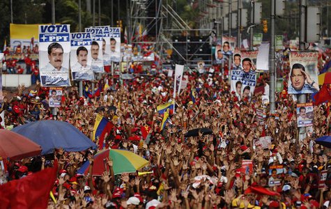 Supporters of Venezuela's acting President and presidential candidate Nicolas Maduro raise their hands during his closing campaign rally in Supporters of Venezuela's acting President and presidential candidate Nicolas Maduro raise their hands during his closing campaign rally in