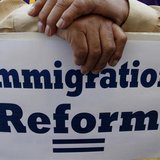 A man holds an immigration reform protest sign during a rally for immigration reform near Senator Dianne Feinstein's office, in Los Angeles, A man holds an immigration reform protest sign during a rally for immigration reform near Senator Dianne Feinstein's office, in Los Angeles,