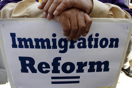 A man holds an immigration reform protest sign during a rally for immigration reform near Senator Dianne Feinstein's office, in Los Angeles, A man holds an immigration reform protest sign during a rally for immigration reform near Senator Dianne Feinstein's office, in Los Angeles,