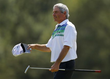 Fred Couples of the U.S. waves after sinking a birdie putt on the 18th green during second round play in the 2013 Masters golf tournament at Fred Couples of the U.S. waves after sinking a birdie putt on the 18th green during second round play in the 2013 Masters golf tournament at
