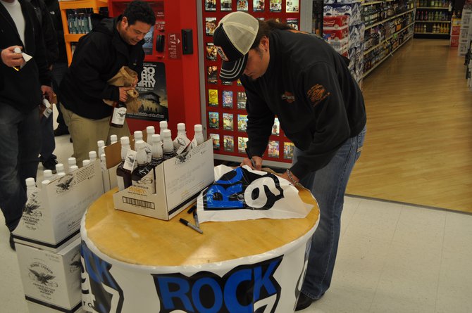 Jesse putting his marks on a Rock 94.7 banner