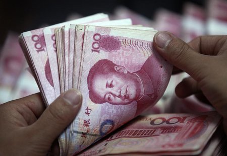 A bank clerk counts Chinese yuan banknotes at a branch of Industrial and Commercial Bank of China in Huaibei, Anhui province, June 8, 2012. A bank clerk counts Chinese yuan banknotes at a branch of Industrial and Commercial Bank of China in Huaibei, Anhui province, June 8, 2012.