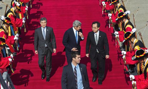 U.S. Secretary of State John Kerry (C) speaks with U.S. Ambasador to South Korea Sung Y. Kim (R) as they walk past a South Korean honor guar U.S. Secretary of State John Kerry (C) speaks with U.S. Ambasador to South Korea Sung Y. Kim (R) as they walk past a South Korean honor guar
