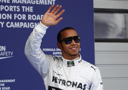 Mercedes Formula One driver Lewis Hamilton of Britain waves as he celebrates taking pole position after the qualifying session for the Chine Mercedes Formula One driver Lewis Hamilton of Britain waves as he celebrates taking pole position after the qualifying session for the Chine