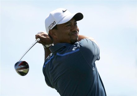 Tiger Woods hits his tee shot on the first hole during third round play in the 2013 Masters golf tournament at the Augusta National Golf Clu Tiger Woods hits his tee shot on the first hole during third round play in the 2013 Masters golf tournament at the Augusta National Golf Clu