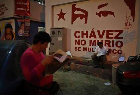 Members of the Venezuela's acting president and presidential candidate Nicolas Maduro campaign team, or 'Commando Hugo Chavez', read newspap Members of the Venezuela's acting president and presidential candidate Nicolas Maduro campaign team, or 'Commando Hugo Chavez', read newspap