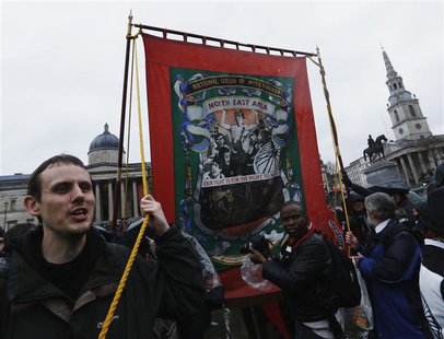 A man carries a banner representing the National Union of Mineworkers through the crowd at a party to celebrate the death of the late former A man carries a banner representing the National Union of Mineworkers through the crowd at a party to celebrate the death of the late former