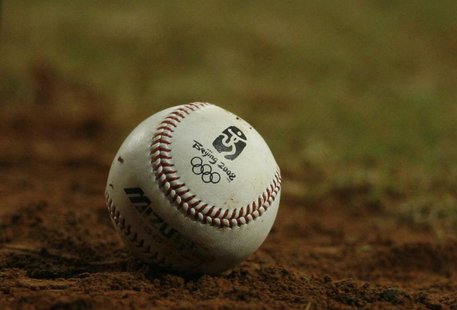 A baseball with the Olympic logo lies on the field during the U.S.-China baseball game at the Beijing 2008 Olympic Games August 18, 2008. RE A baseball with the Olympic logo lies on the field during the U.S.-China baseball game at the Beijing 2008 Olympic Games August 18, 2008. RE