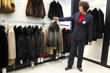A sales woman displays a mink coat to customers at a shopping mall in Shanghai, April 4, 2013. Fueled by demand for high-end clothing and lu A sales woman displays a mink coat to customers at a shopping mall in Shanghai, April 4, 2013. Fueled by demand for high-end clothing and lu