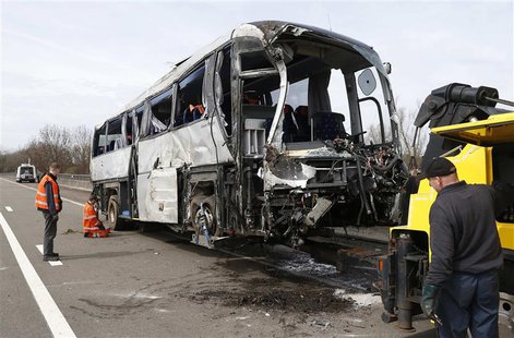Workers inspect the wreckage of a Polish passenger bus, which swerved from the road on the E34 highway, in Ranst, near Antwerp April 14, 201 Workers inspect the wreckage of a Polish passenger bus, which swerved from the road on the E34 highway, in Ranst, near Antwerp April 14, 201