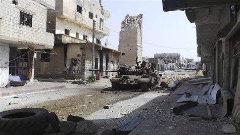 An abandoned tank is seen on a street near the minaret of the Omari mosque, which was damaged by what activists said was shelling by forces An abandoned tank is seen on a street near the minaret of the Omari mosque, which was damaged by what activists said was shelling by forces