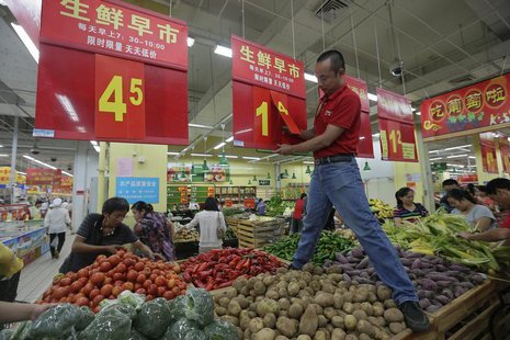 An employee adjusts a price tag at a supermarket in Wuhan, Hubei province, September 9, 2012. REUTERS/Stringer An employee adjusts a price tag at a supermarket in Wuhan, Hubei province, September 9, 2012. REUTERS/Stringer