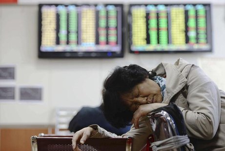 An investor naps in front of screens showing stock information at a brokerage house in Qingdao, Shandong province April 12, 2013. REUTERS/Ch An investor naps in front of screens showing stock information at a brokerage house in Qingdao, Shandong province April 12, 2013. REUTERS/Ch