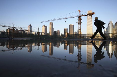 A worker walks past a pool of water inside a construction site in central Beijing, April 6, 2013. REUTERS/China Daily A worker walks past a pool of water inside a construction site in central Beijing, April 6, 2013. REUTERS/China Daily