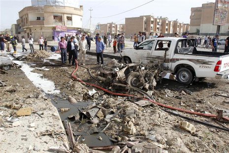 Iraqi security personnel are seen at the site of a bomb attack in Kirkuk, 250 km (155 miles) north of Baghdad, April 15, 2013. REUTERS/Ako R Iraqi security personnel are seen at the site of a bomb attack in Kirkuk, 250 km (155 miles) north of Baghdad, April 15, 2013. REUTERS/Ako R