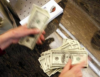 Four thousand U.S. dollars are counted out by a banker counting currency at a bank in Westminster, Colorado November 3, 2009. REUTERS/Rick W Four thousand U.S. dollars are counted out by a banker counting currency at a bank in Westminster, Colorado November 3, 2009. REUTERS/Rick W
