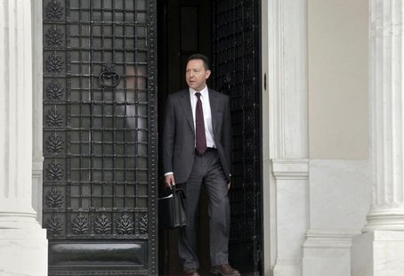 Greek Financial Minister Yannis Stournaras walks off the Premier's office after a meeting with the Greek Prime Minister and the Troika in At Greek Financial Minister Yannis Stournaras walks off the Premier's office after a meeting with the Greek Prime Minister and the Troika in At