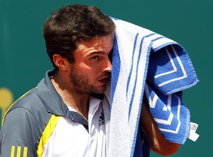 Gilles Simon of France wipes his face during his match against Roberto Bautista Agut of Spain during the first round of the Monte Carlo Mast Gilles Simon of France wipes his face during his match against Roberto Bautista Agut of Spain during the first round of the Monte Carlo Mast