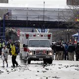 A runner is escorted from the scene after explosions went off at the 117th Boston Marathon in Boston, Massachusetts April 15, 2013.  (Reuters)