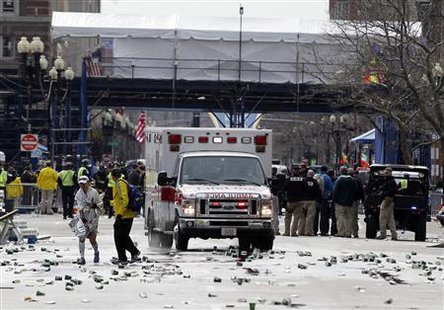 A runner is escorted from the scene after explosions went off at the 117th Boston Marathon in Boston, Massachusetts April 15, 2013. (Reuters) A runner is escorted from the scene after explosions went off at the 117th Boston Marathon in Boston, Massachusetts April 15, 2013. (Reuters)