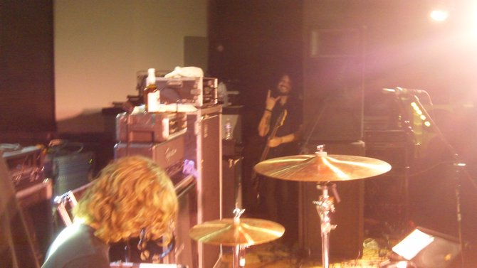 L-R: Wayland drummer Tyler gets ready to play while bassist Dean lurks behind the speakers.