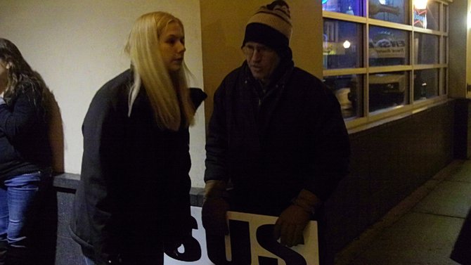 Protestor trying to get a listener's phone number outside the show.