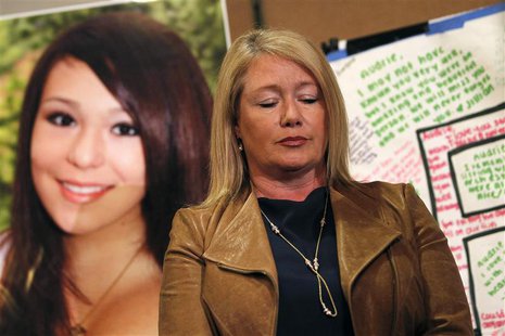 Sheila Pott pauses in front of a portrait of her teenage daughter, Audrie Pott, at a news conference in San Jose, California April 15, 2013. Sheila Pott pauses in front of a portrait of her teenage daughter, Audrie Pott, at a news conference in San Jose, California April 15, 2013.