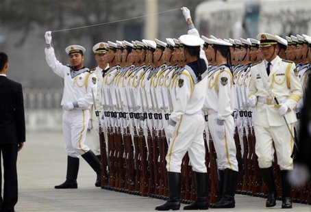 Members of the People's Liberation Army's navy guard of honour prepare to use a string to ensure that soldiers stand in a straight line befo Members of the People's Liberation Army's navy guard of honour prepare to use a string to ensure that soldiers stand in a straight line befo