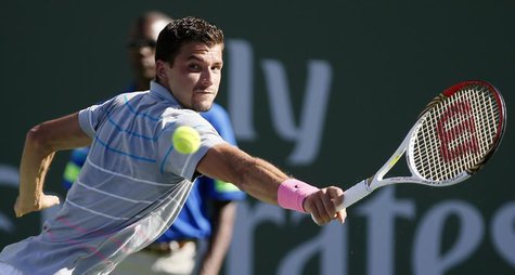 Grigor Dimitrov of Bulgaria returns a shot against Novak Djokovic of Serbia during their men's singles match at the BNP Paribas Open ATP ten Grigor Dimitrov of Bulgaria returns a shot against Novak Djokovic of Serbia during their men's singles match at the BNP Paribas Open ATP ten