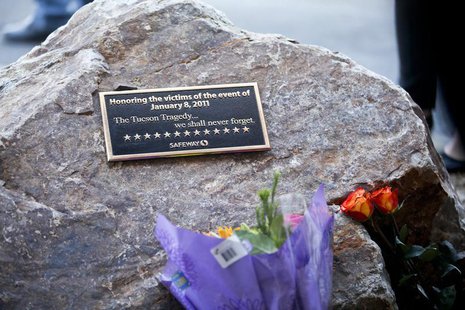 A plaque and flowers for victims of the January 8, 2011 Tucson shooting, are seen during a news conference at the Safeway grocery store park A plaque and flowers for victims of the January 8, 2011 Tucson shooting, are seen during a news conference at the Safeway grocery store park