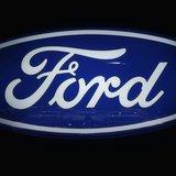 Ford cars are reflected in the company's logo at the carmakers' booth on media day at the Paris Mondial de l'Automobile, September 28, 2012. Ford cars are reflected in the company's logo at the carmakers' booth on media day at the Paris Mondial de l'Automobile, September 28, 2012.